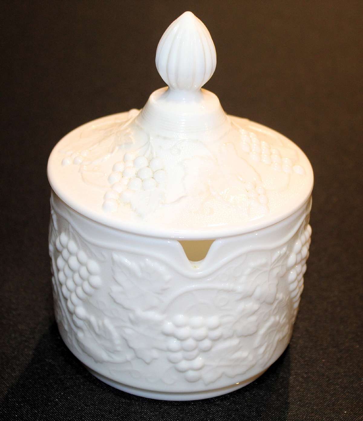 Up for sale is this Imperial Glass Grape Milk Glass Candy Jar in excellent condition with no chips or cracks. Measures approx. 3 3/8"T without the lid and 4 1/4"W. Marked on the reverse with the IG. Shipping Excludes: Alaska/Hawaii, US Protecto