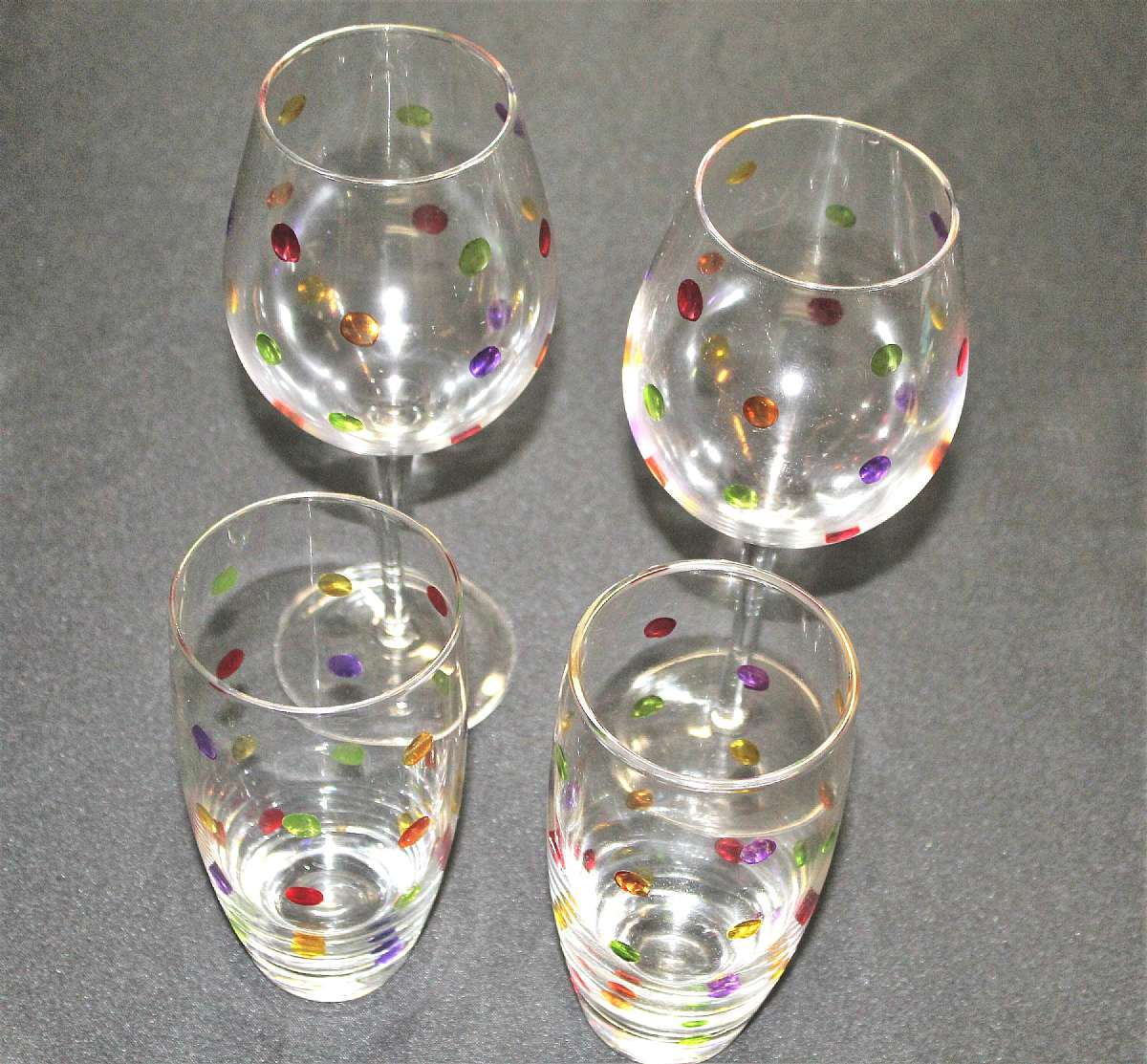 Up for sale are these Pier 1 P1C67 Polka Dot Confetti Set Of Four Glasses in excellent condition with no chips or cracks. The large glasses measure approx. 10 1/8"T by 3"W and the two tumblers are 7"T by 3 1/4"W. Shipping Excludes: Al