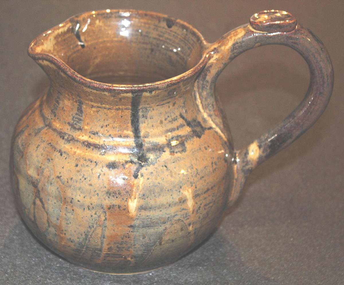 Up for sale is this Art Studio Signed Pottery Pitcher Jug in excellent condition with no chips or cracks. It measures approx. 6 1/2"T by 4"W at the top and holds approx. 42 ounces.Shipping Excludes: Alaska/Hawaii, US Protectorates, APO/FPO, PO