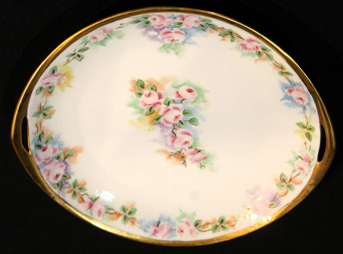 Up for sale is this Schlackenwerth Czechoslovakia Antique Pink Rose Floral Handled Plate in great condition with no chips, cracks or crazing. Minor Gold Wear. The plate measures approx. 10"W.  Shipping Excludes: Alaska/Hawaii, US Protectorates, APO/