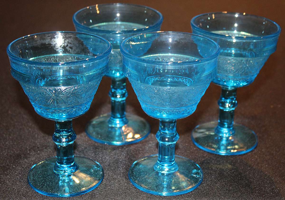 Up for sale are these Four Colony Blue Sandwich Pattern Champagne or Sherbet Glasses in excellent condition with no chips or cracks. The glasses measure approx. 5 3/8"T by 3 1/2"W.  Shipping Excludes: Alaska/Hawaii, US Protectorates, APO/FPO, P