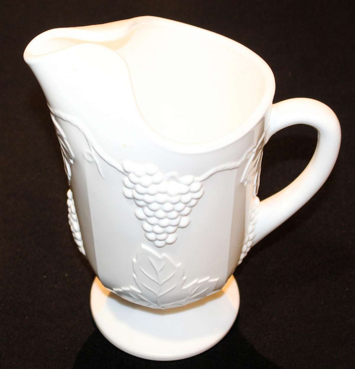 Up for sale is this Colony Harvest Milk Glass 72 Ounce Ice Lip Footed Pitcher in excellent condition with no chips or cracks. The pitcher measures approx. 10 3/8" Tall by 6"W. Shipping Excludes: Alaska/Hawaii, US Protectorates, APO/FPO, PO Box