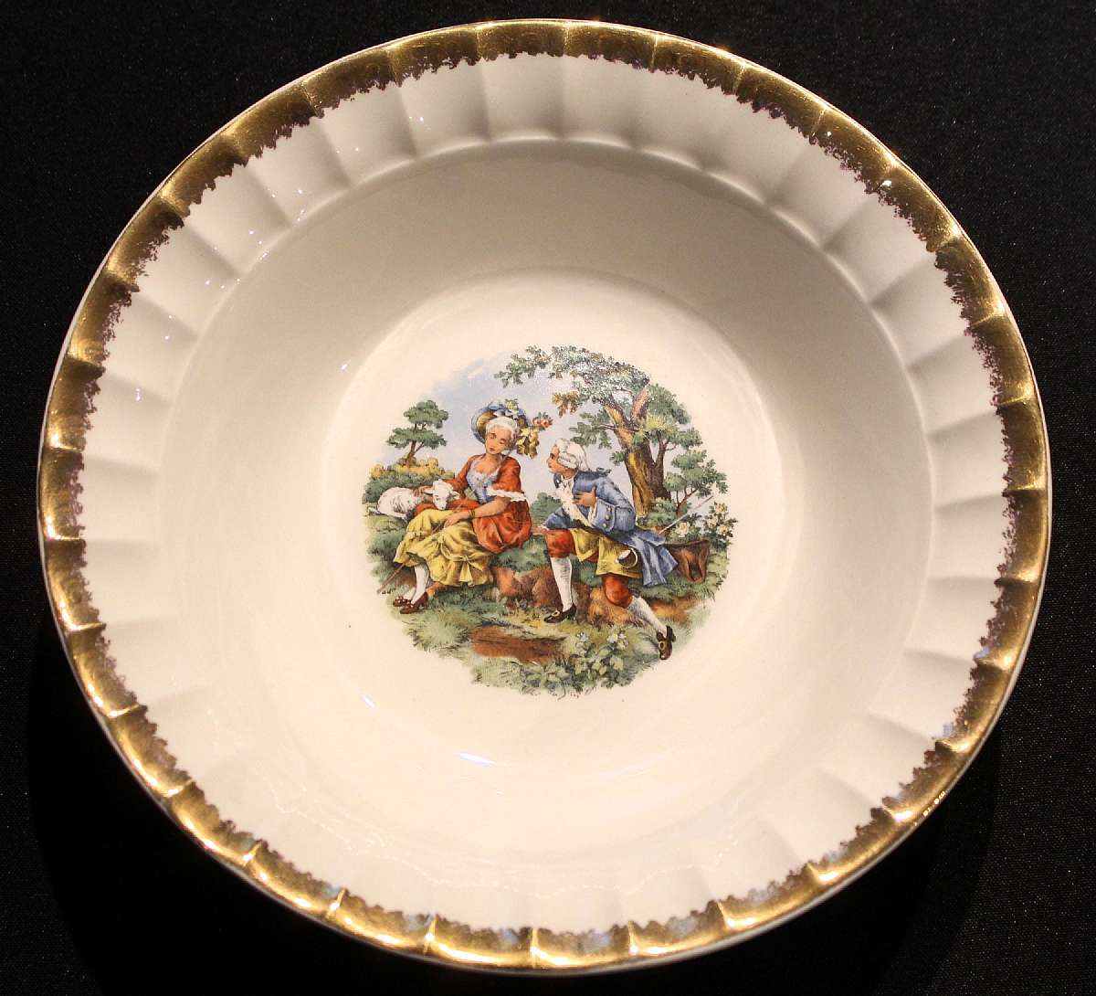 Up for sale is this Prim Rose China Loving Couple Round Serving Bowl With Gold Trim in excellent condition with no chips or cracks or crazing. The bowl measures approx. 9 3/8"W by 2 1/2"D.  Please see my other sales for more of this rare pattern