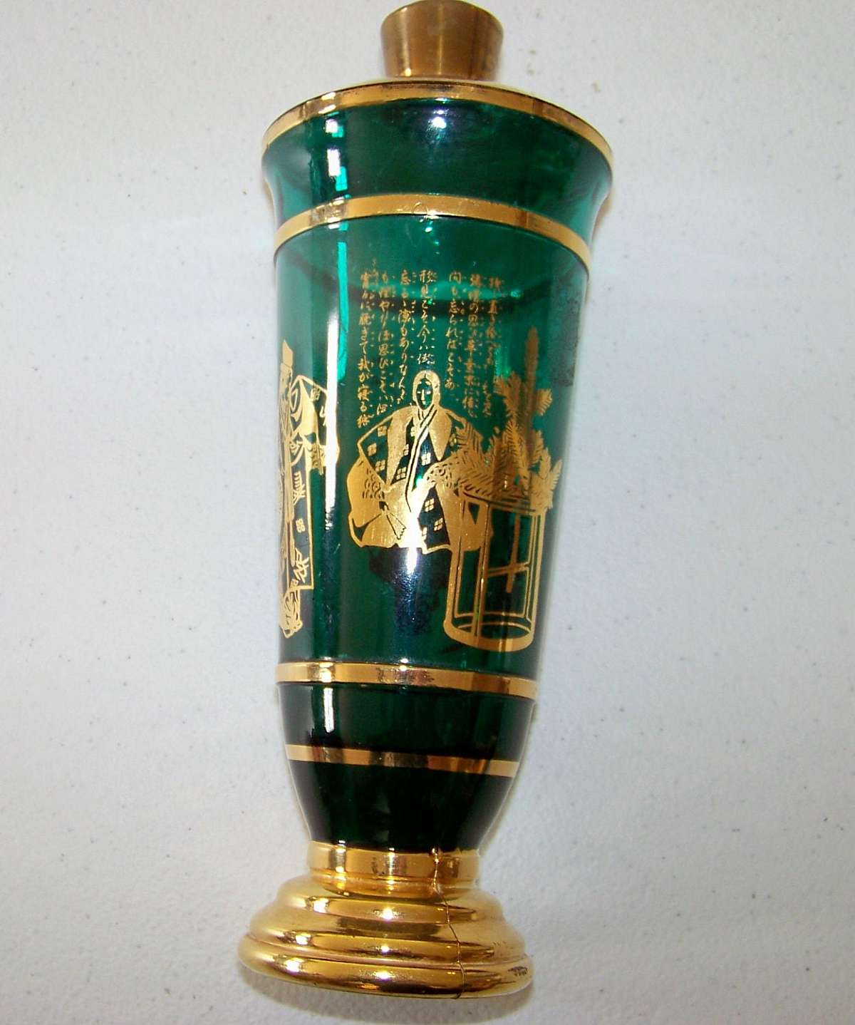 Up for sale is this Sake Green Glass Tokyo Japan Bottle in great condition with no chips or cracks. It measures approx. 8 1/4 inches tall not measuring the lid.Shipping Excludes: Alaska/Hawaii, US Protectorates, APO/FPO, PO BoxShipping Provided to the U