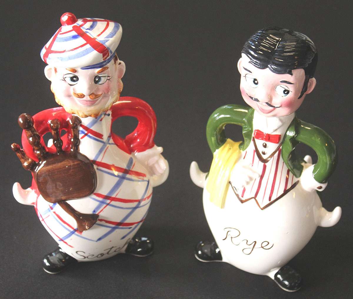Up for sale are these two Rye & Scotch Figurine Decanter Liquor Bottles. Some wear on corks. The decanters measure approx. 9 1/2"T. They have some paint wear, minor crazing & some cork stopper wear. No chips. Shipping Excludes: Alaska/Hawaii