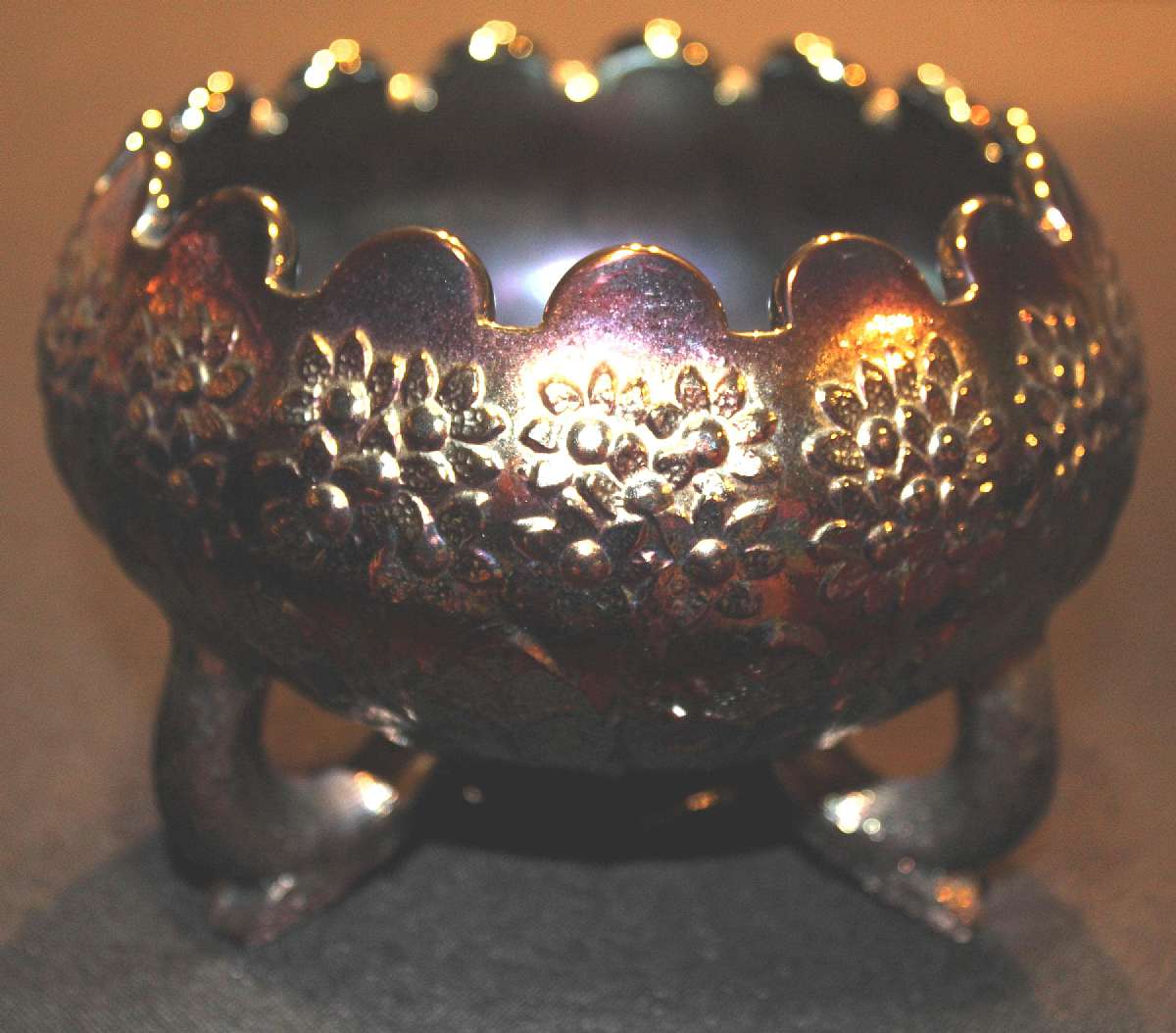 Up for sale is this Fenton Amethyst Carnival Glass Three Toed Cupped Bowl in good condition with no cracks. There is a chip on one of the feet pictured. The bowl measures approx. 4"T by 5 3/8"W.Shipping Excludes: Alaska/Hawaii, US Protectorates
